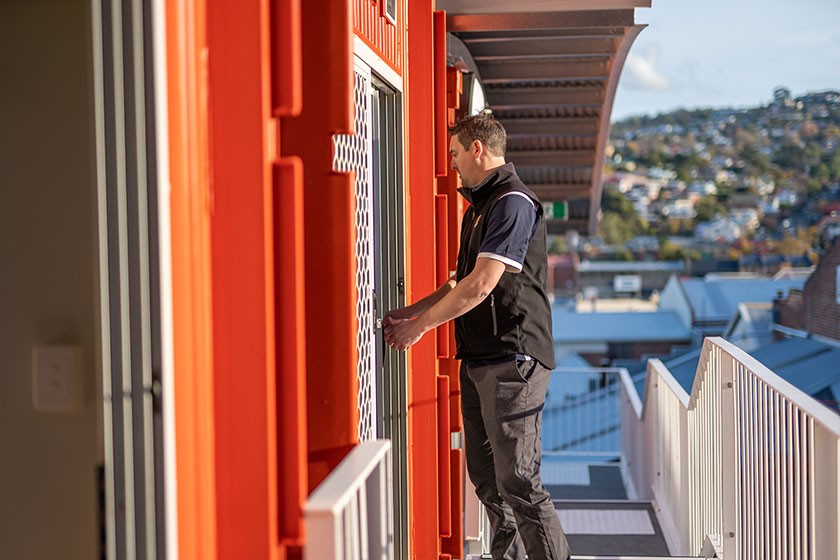 Royal Wolf BDM Michael Nicholson locks up completed the pods, ready for the residents to move in. Photo: Nick Hansen